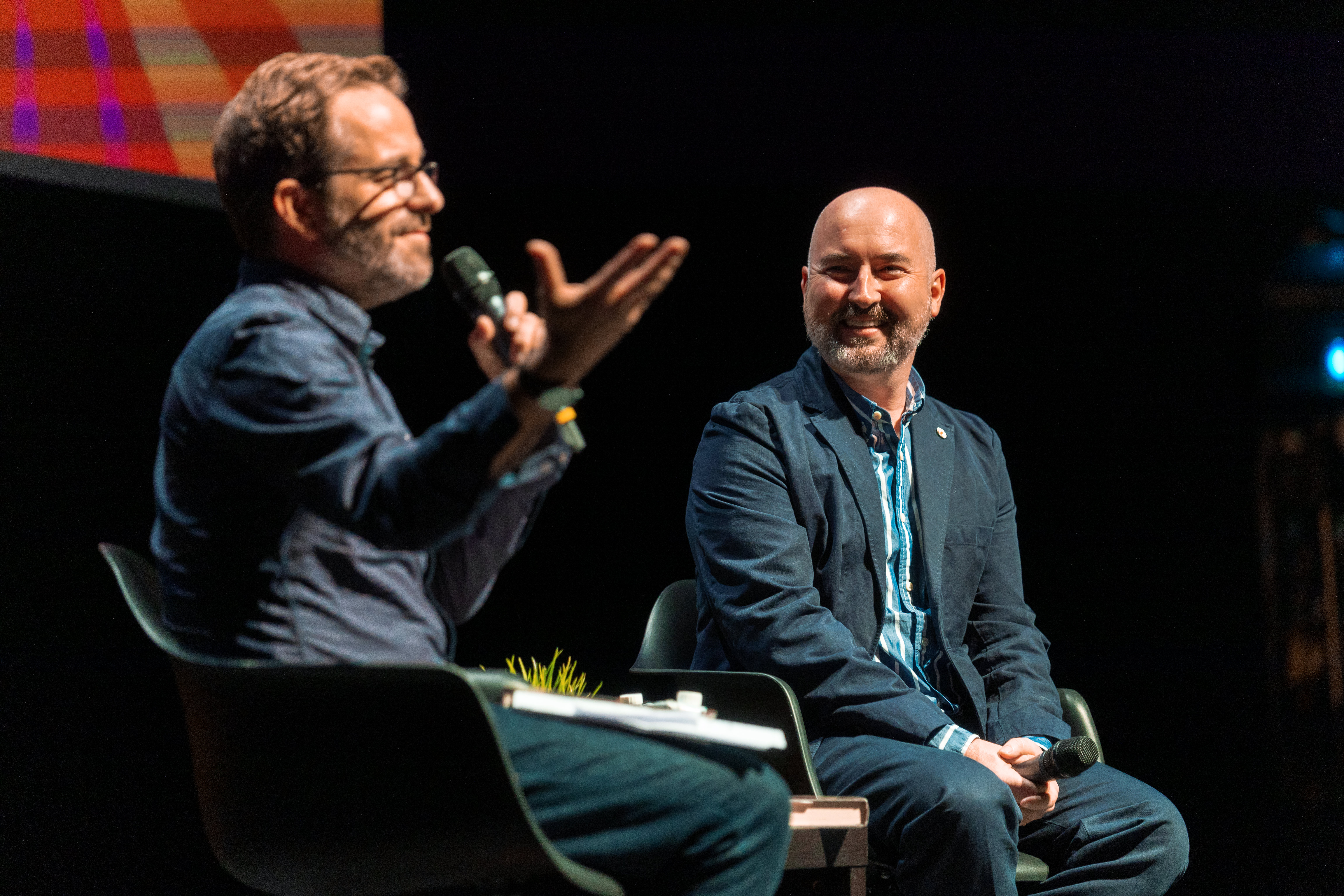 two men on stage talking